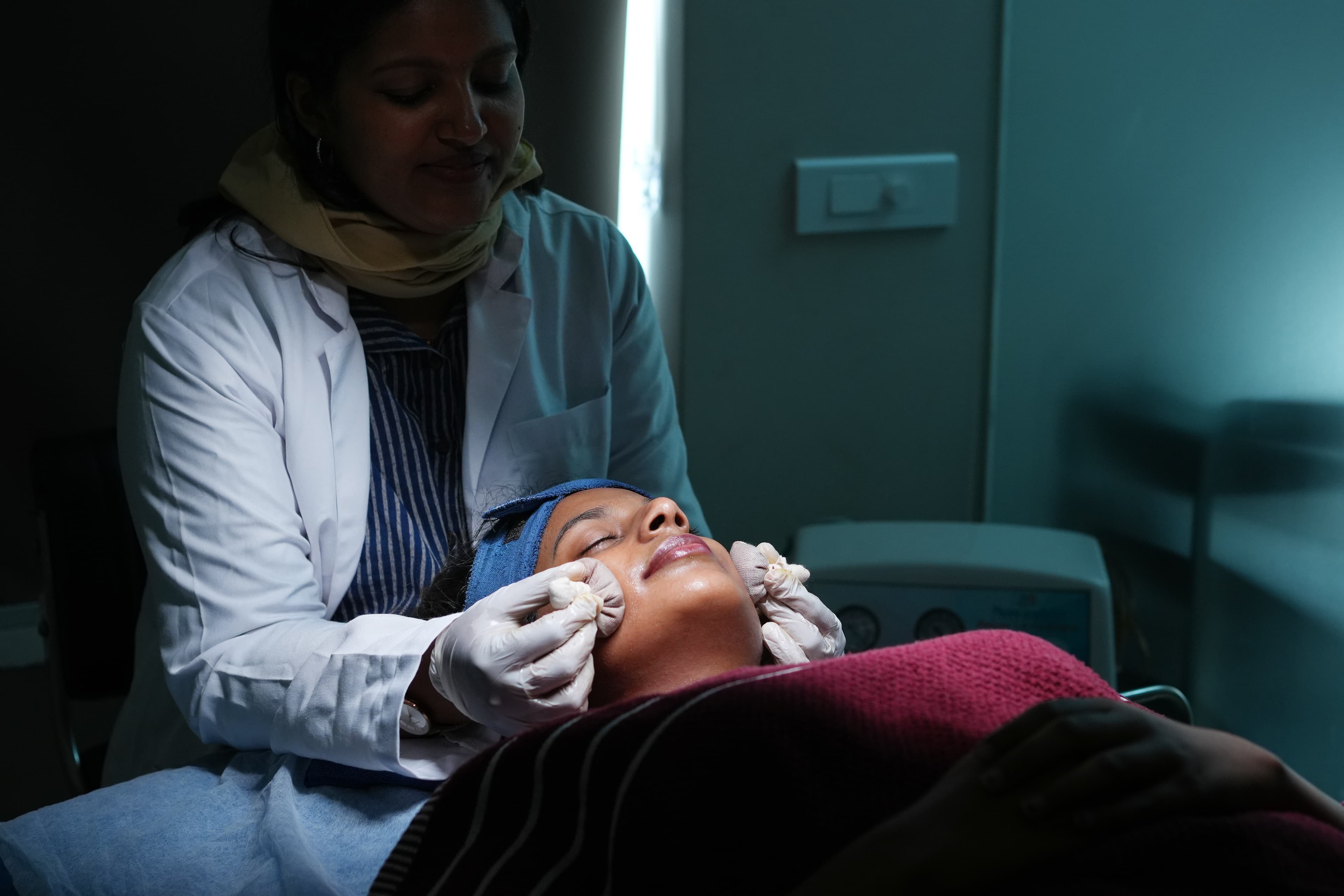 Doctor performing luxury Ayurvedic facial treatment at Gloveda Experience